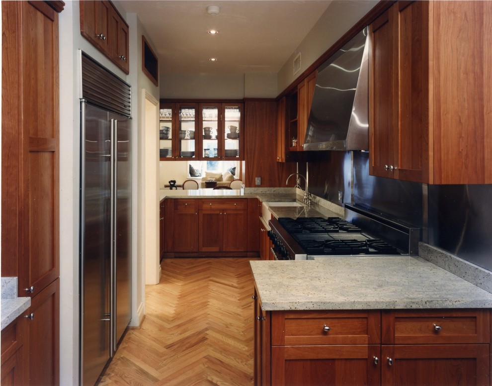 Foto på ett avskilt, mellanstort funkis u-kök, med en rustik diskho, skåp i shakerstil, skåp i mörkt trä, granitbänkskiva, grått stänkskydd, stänkskydd i metallkakel, rostfria vitvaror, mellanmörkt trägolv och beiget golv