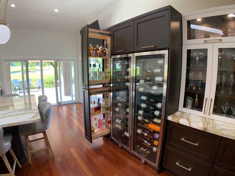 Inspiration for a large traditional l-shaped kitchen pantry in Orange County with a belfast sink, shaker cabinets, dark wood cabinets, granite worktops, multi-coloured splashback, cement tile splashback, stainless steel appliances, dark hardwood flooring, an island, brown floors, multicoloured worktops and a timber clad ceiling.