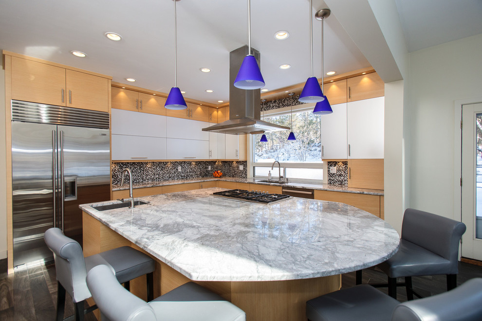 Open concept kitchen - large modern l-shaped painted wood floor open concept kitchen idea in Boston with a drop-in sink, flat-panel cabinets, light wood cabinets, marble countertops, multicolored backsplash, stainless steel appliances and an island