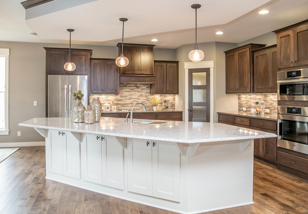 Inspiration for a timeless l-shaped medium tone wood floor eat-in kitchen remodel in Minneapolis with a single-bowl sink, shaker cabinets, medium tone wood cabinets, quartz countertops, gray backsplash, ceramic backsplash, stainless steel appliances and an island