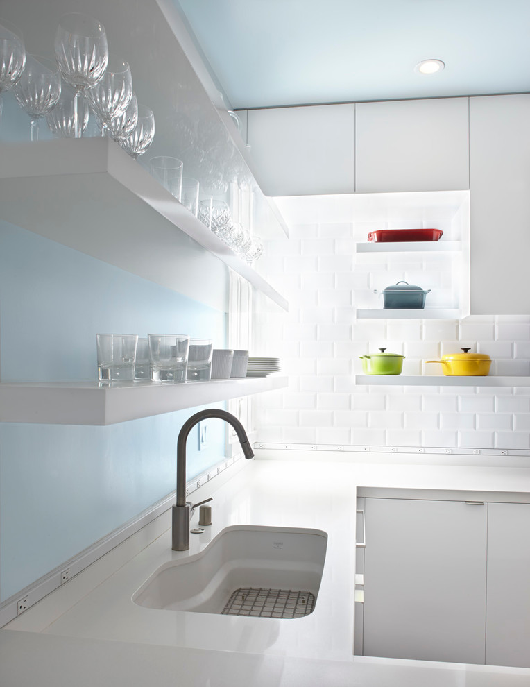 Modelo de cocina moderna con armarios con paneles lisos, puertas de armario blancas, encimera de cuarcita y salpicadero blanco