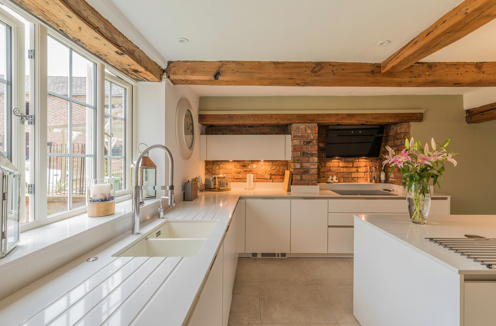 Inspiration for a rural kitchen in Cheshire with flat-panel cabinets, white cabinets and a breakfast bar.