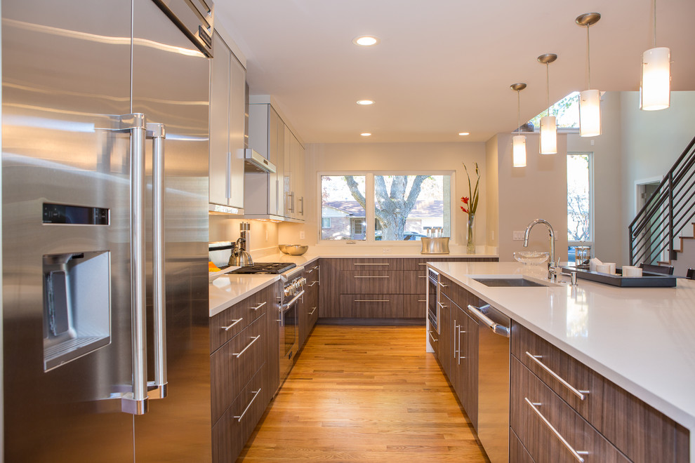 This is an example of a medium sized modern l-shaped kitchen in Denver with a built-in sink, beaded cabinets, white cabinets, medium hardwood flooring, an island, brown floors and white worktops.