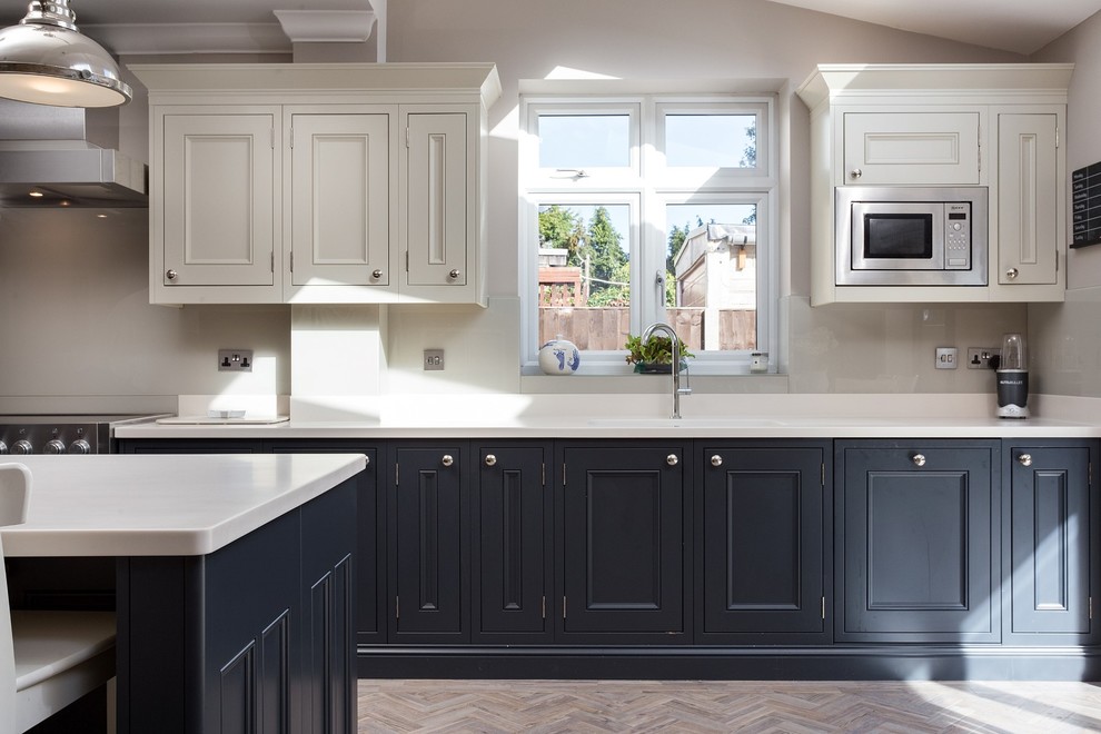 Inspiration for a large victorian l-shaped open plan kitchen in London with shaker cabinets and an island.