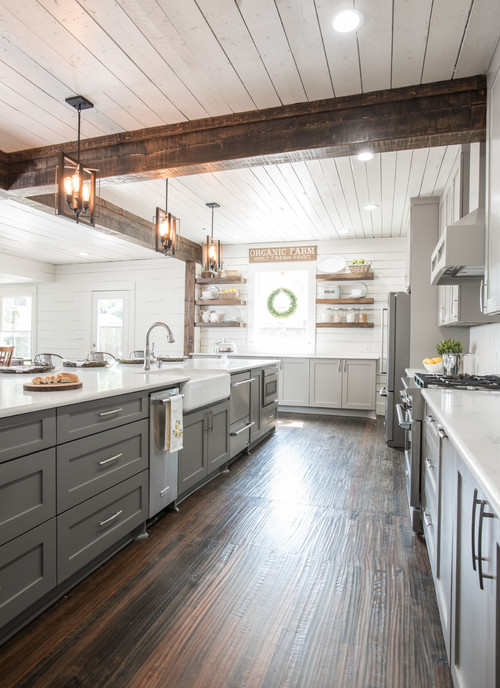Custom gray cabinets, quartz counter tops, white arabesque back splash, under-cabinet lighting, and upgraded appliances were just a few of the incredible additions to this space. Original features that were kept included the original hardwood flooring, the original windows,