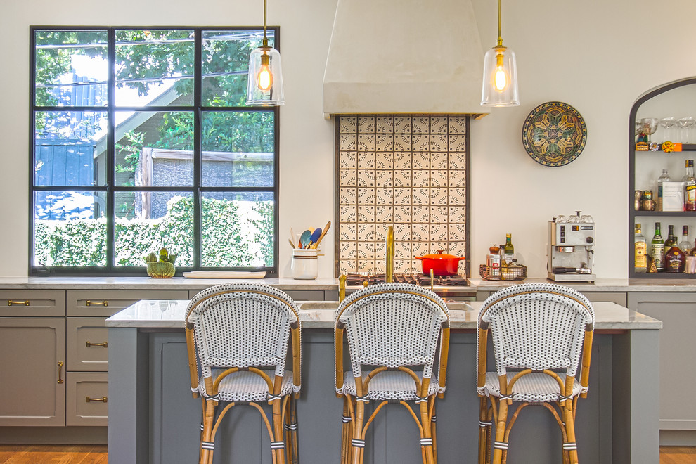 Mediterrane Küche mit Schrankfronten im Shaker-Stil, grauen Schränken, braunem Holzboden und Kücheninsel in Austin