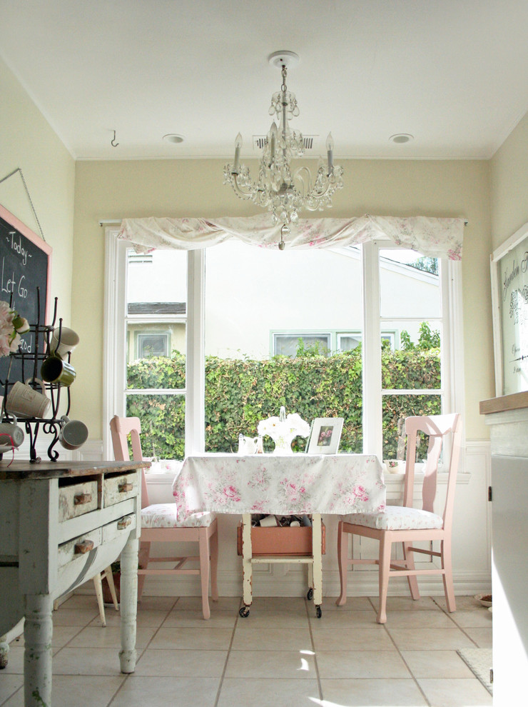 Inspiration for a small vintage l-shaped kitchen/diner in Santa Barbara with a belfast sink, glass-front cabinets, white cabinets, wood worktops, white splashback, stainless steel appliances, ceramic flooring and no island.