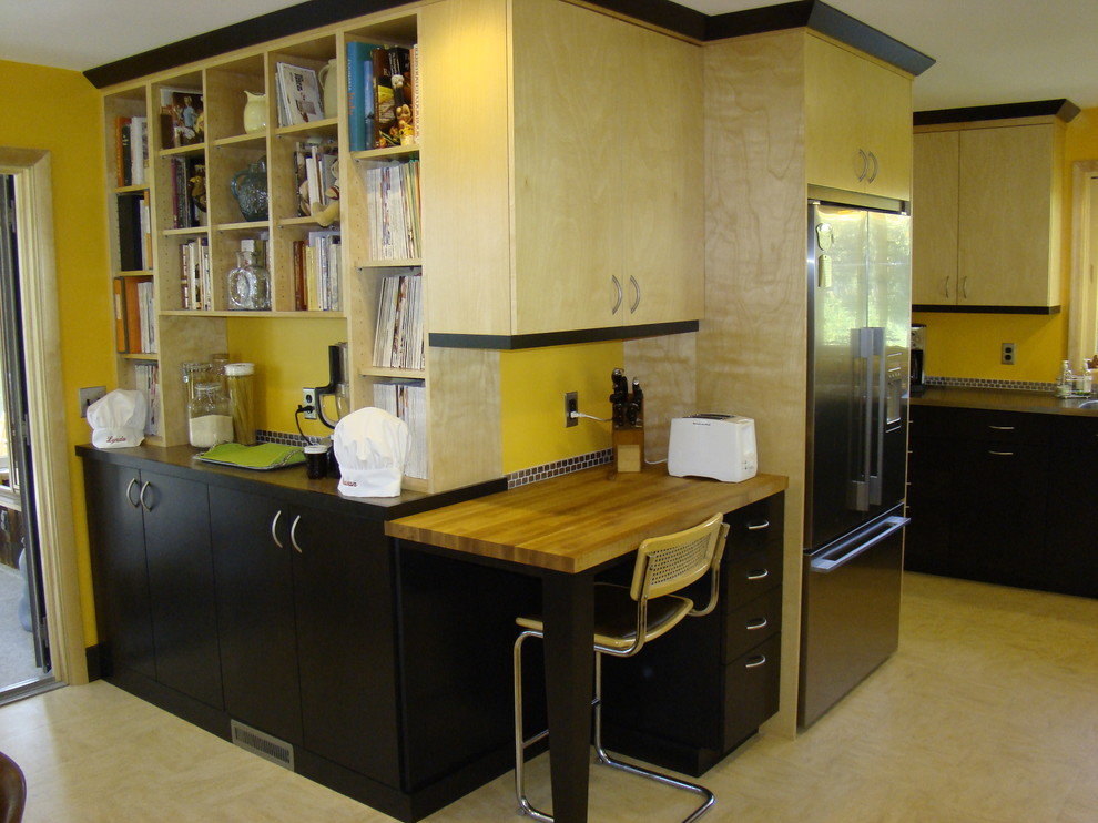 Inspiration for a large mid-century modern u-shaped linoleum floor enclosed kitchen remodel in Portland Maine with an integrated sink, flat-panel cabinets, light wood cabinets, wood countertops, metallic backsplash, metal backsplash, stainless steel appliances and no island
