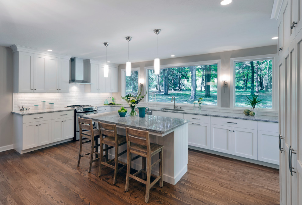 Transitional eat-in kitchen photo in Cleveland with a single-bowl sink, shaker cabinets, white cabinets, granite countertops, white backsplash, subway tile backsplash and stainless steel appliances