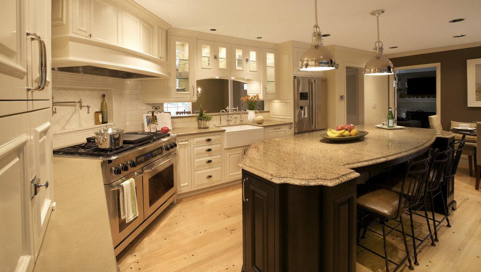 Design ideas for a classic kitchen in Portland with glass-front cabinets, stainless steel appliances and a belfast sink.