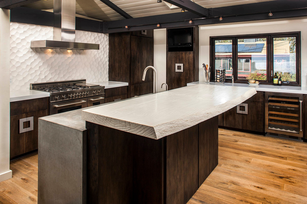 Inspiration for a mid-sized craftsman u-shaped light wood floor eat-in kitchen remodel in San Diego with an integrated sink, flat-panel cabinets, dark wood cabinets, concrete countertops, white backsplash, cement tile backsplash and stainless steel appliances