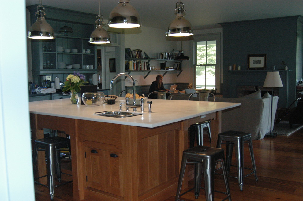 Country l-shaped open concept kitchen photo in New York with shaker cabinets, medium tone wood cabinets, marble countertops, gray backsplash and an island