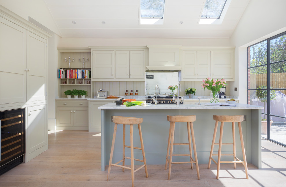 Danish eat-in kitchen photo in Surrey with shaker cabinets and an island