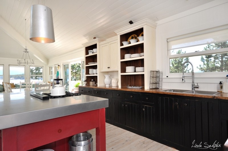 Eat-in kitchen - large coastal l-shaped light wood floor eat-in kitchen idea in Vancouver with a double-bowl sink, open cabinets, beige cabinets and an island