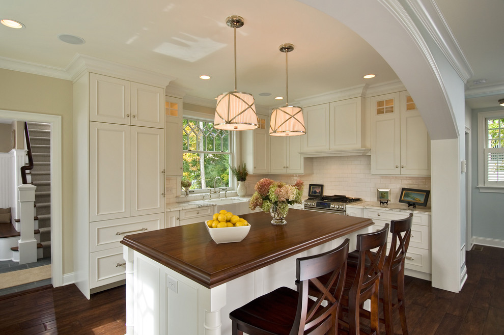 Inspiration for a timeless kitchen remodel in New York with subway tile backsplash and wood countertops