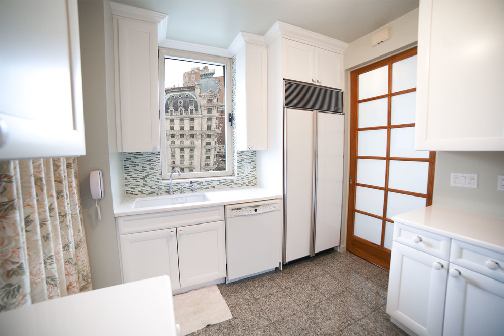 Example of a mid-sized transitional u-shaped porcelain tile enclosed kitchen design in New York with an undermount sink, shaker cabinets, white cabinets, multicolored backsplash, ceramic backsplash, white appliances and no island