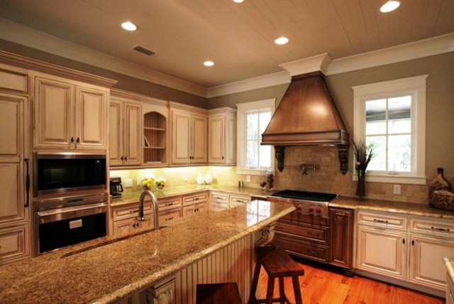 This is an example of a traditional u-shaped kitchen/diner in Miami with distressed cabinets.