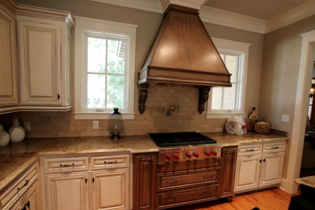 Eat-in kitchen - traditional u-shaped eat-in kitchen idea in Miami with distressed cabinets