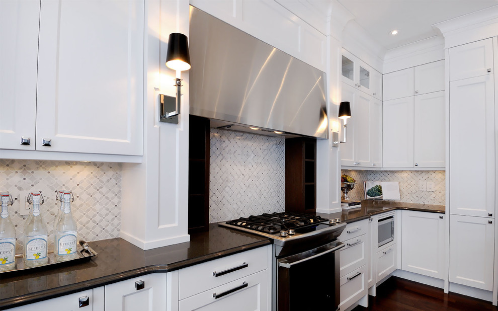 Contemporary kitchen in Other with recessed-panel cabinets, white cabinets, white splashback and mosaic tiled splashback.