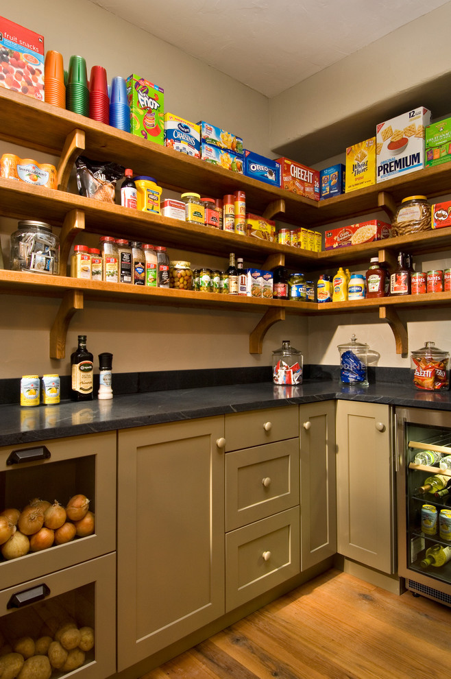 Kitchen pantry - rustic medium tone wood floor kitchen pantry idea in New York with open cabinets