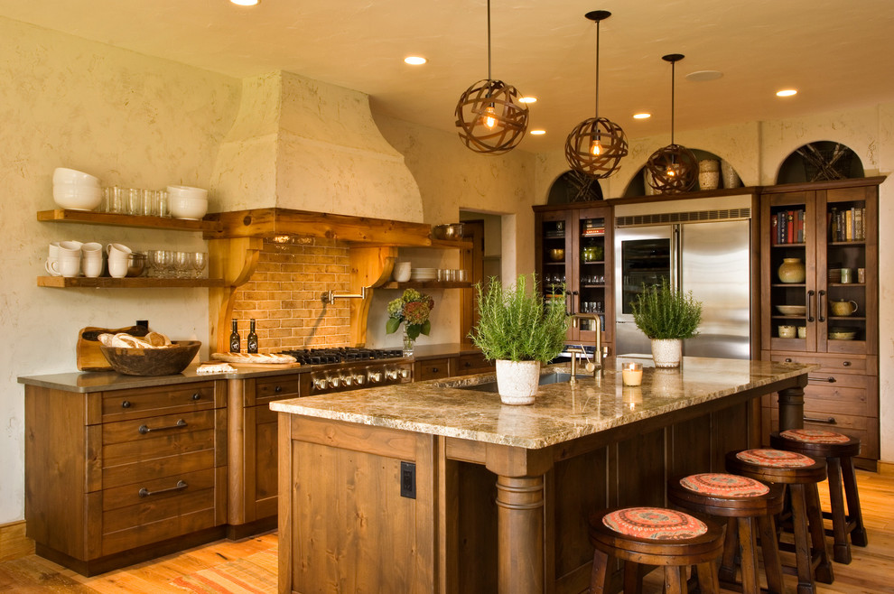 Inspiration for a rustic kitchen remodel in New York with glass-front cabinets, stainless steel appliances and subway tile backsplash