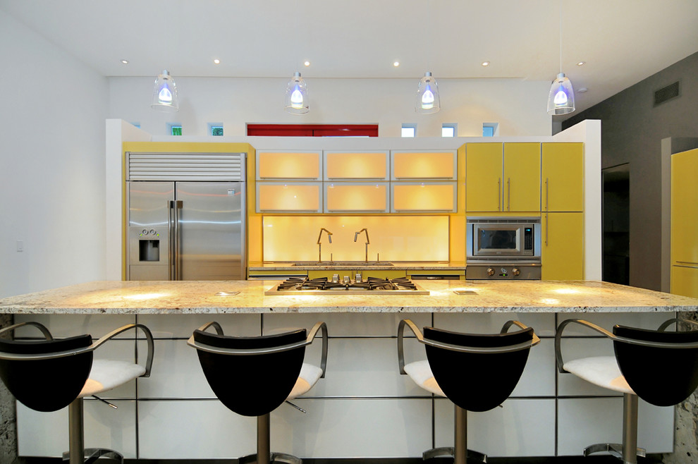 Design ideas for a medium sized modern single-wall open plan kitchen in Tampa with yellow cabinets, granite worktops, glass sheet splashback, stainless steel appliances and an island.