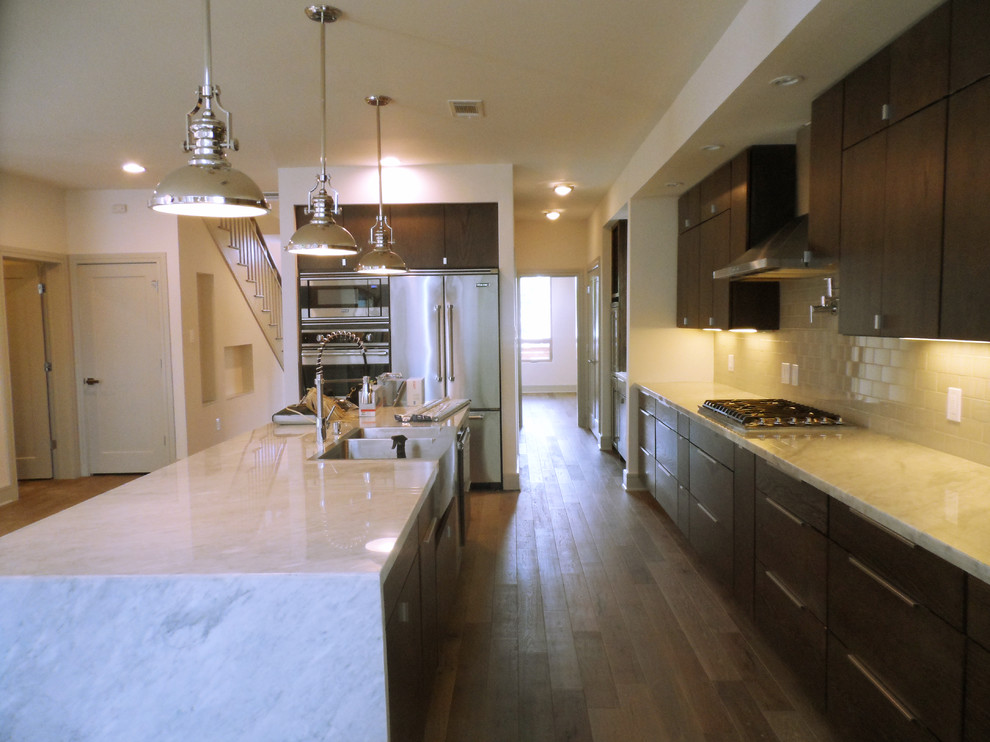 Immagine di una cucina minimal con lavello a doppia vasca, ante in legno bruno, top in marmo, paraspruzzi beige, elettrodomestici in acciaio inossidabile e parquet chiaro