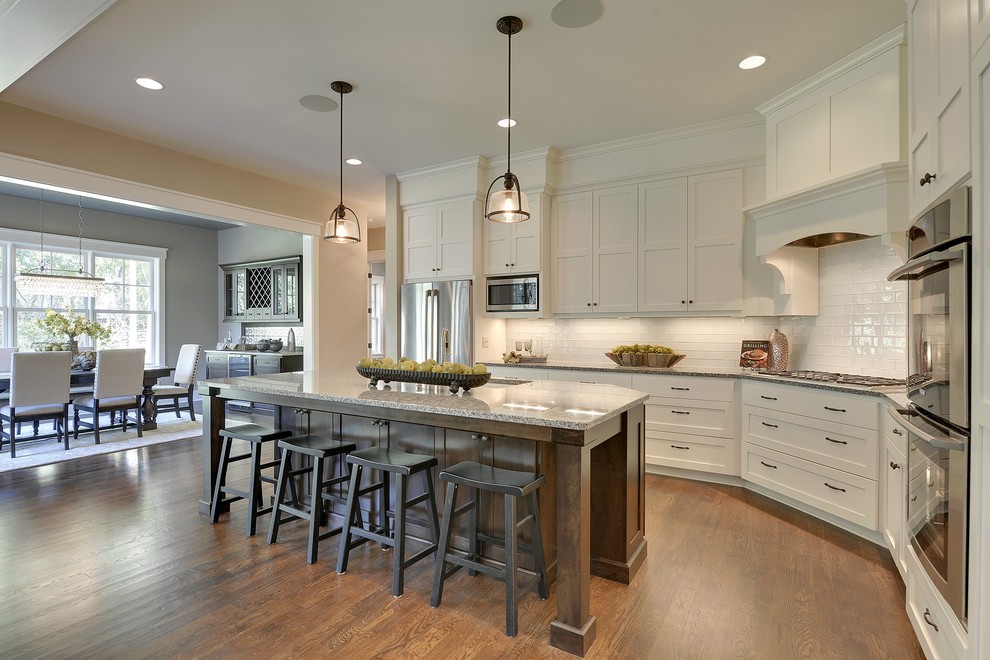 Inspiration for a timeless kitchen remodel in Minneapolis with recessed-panel cabinets, white cabinets, white backsplash, subway tile backsplash and stainless steel appliances