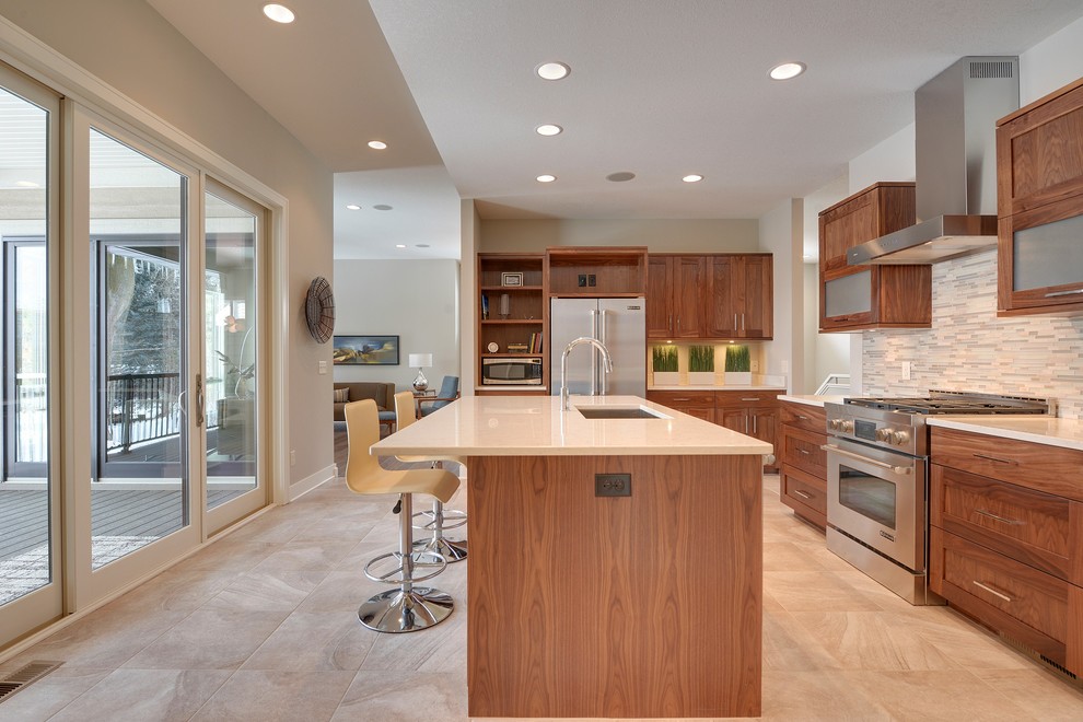 Eat-in kitchen - mid-sized modern single-wall porcelain tile eat-in kitchen idea in Minneapolis with an undermount sink, recessed-panel cabinets, medium tone wood cabinets, quartz countertops, green backsplash and stainless steel appliances
