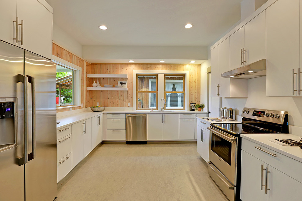 Design ideas for a contemporary u-shaped enclosed kitchen in Seattle with raised-panel cabinets, white cabinets and stainless steel appliances.