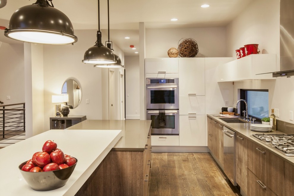 Example of a beach style kitchen design in Seattle with a drop-in sink and white cabinets