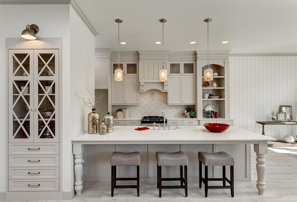 Open concept kitchen - mid-sized traditional galley light wood floor open concept kitchen idea in Boise with an undermount sink, shaker cabinets, gray cabinets, white backsplash, a peninsula, quartz countertops and stainless steel appliances