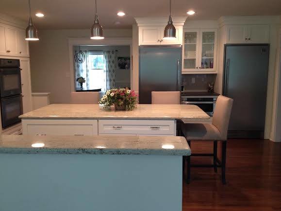 Mid-sized elegant l-shaped medium tone wood floor kitchen photo in Philadelphia with an island, granite countertops and an undermount sink