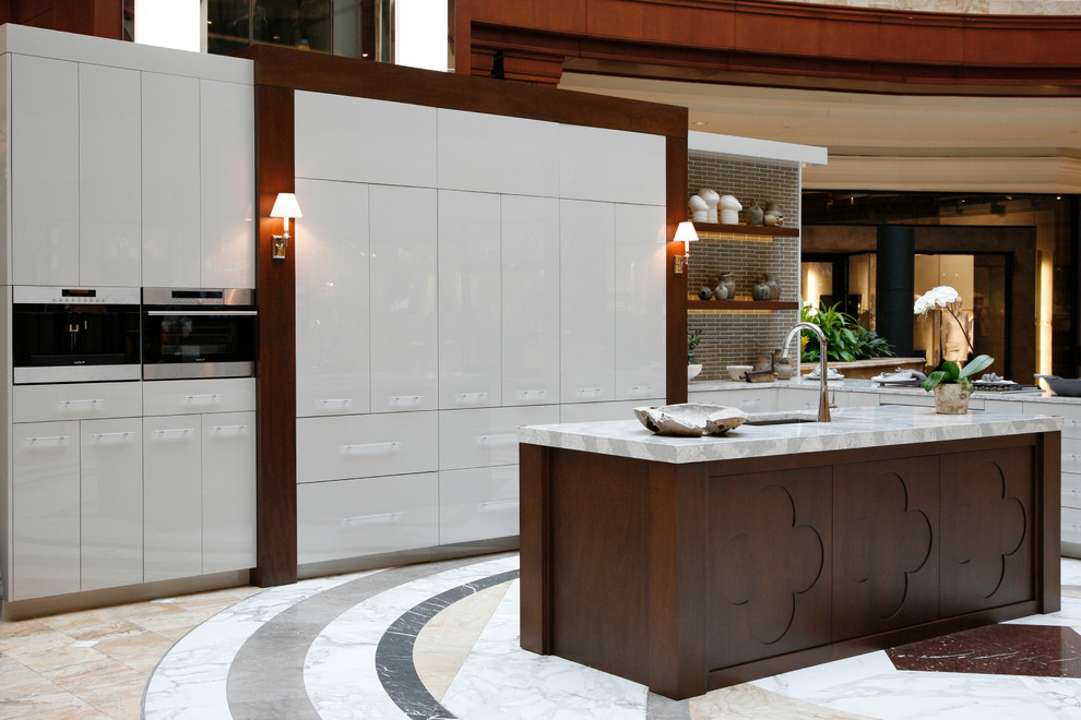 This is an example of a modern kitchen in Atlanta with engineered stone countertops and an island.
