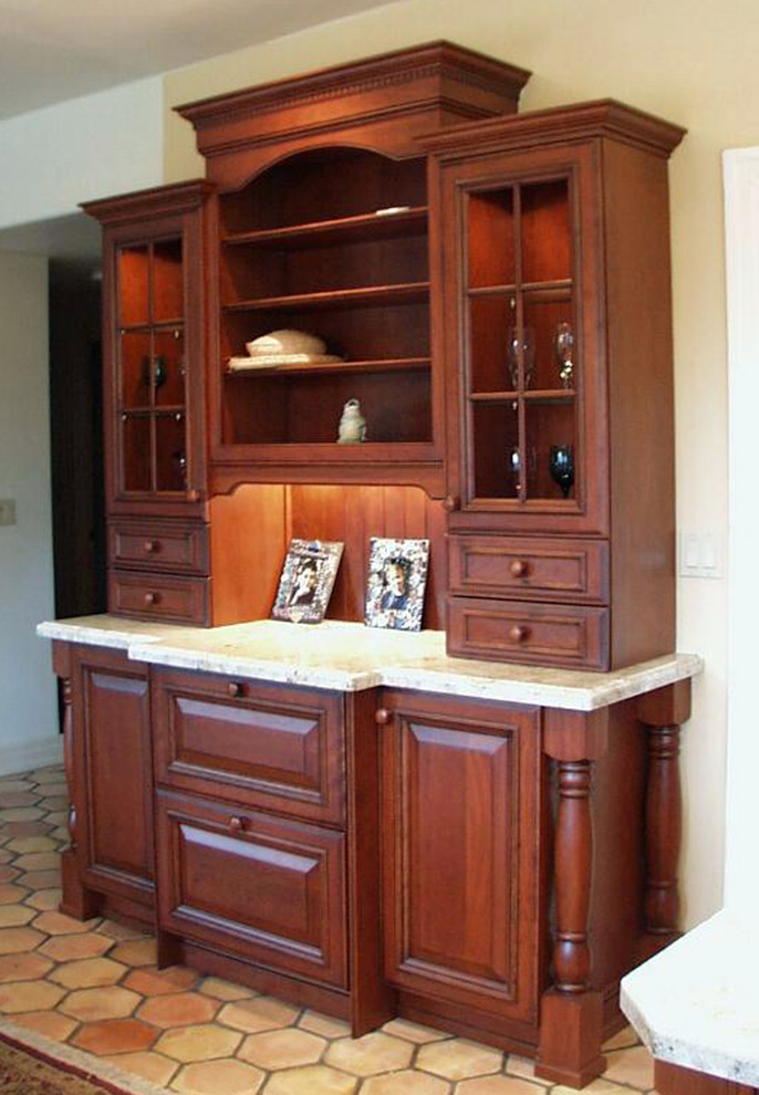 Inspiration for a large mediterranean u-shaped terra-cotta tile enclosed kitchen remodel in San Luis Obispo with an undermount sink, raised-panel cabinets, red cabinets, granite countertops, stone slab backsplash, paneled appliances and an island