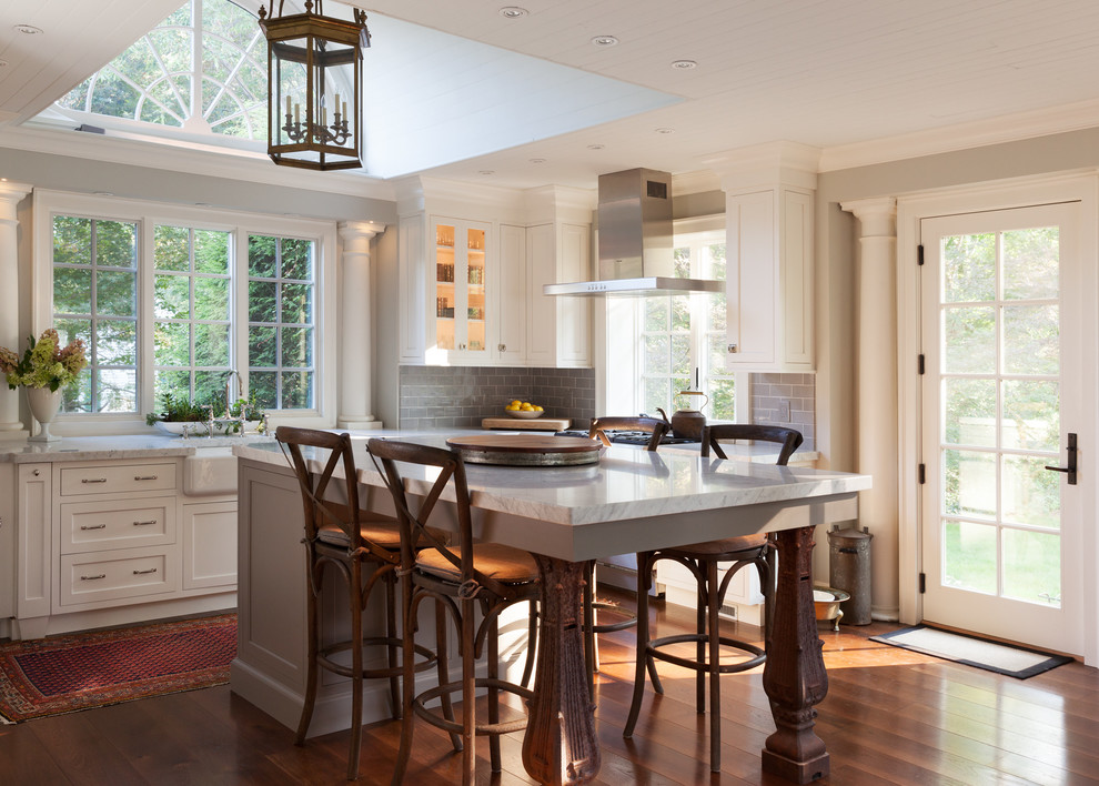 Open concept kitchen - large eclectic u-shaped dark wood floor open concept kitchen idea in Boston with a farmhouse sink, beaded inset cabinets, white cabinets, marble countertops, gray backsplash, ceramic backsplash, stainless steel appliances and an island