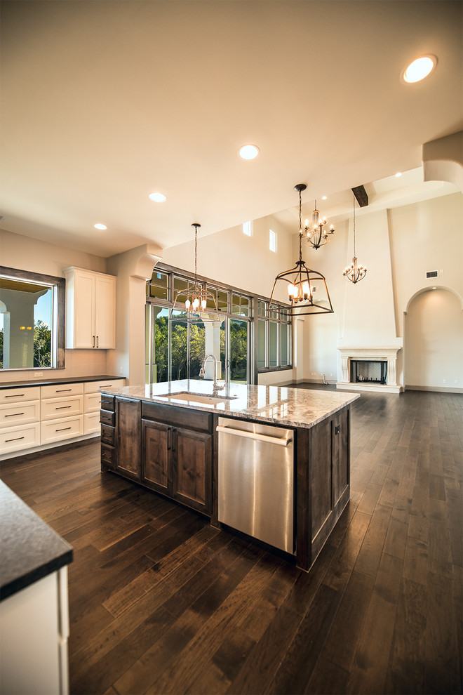 Large tuscan u-shaped dark wood floor eat-in kitchen photo in Austin with a single-bowl sink, white cabinets, granite countertops, white backsplash, mosaic tile backsplash, stainless steel appliances and an island