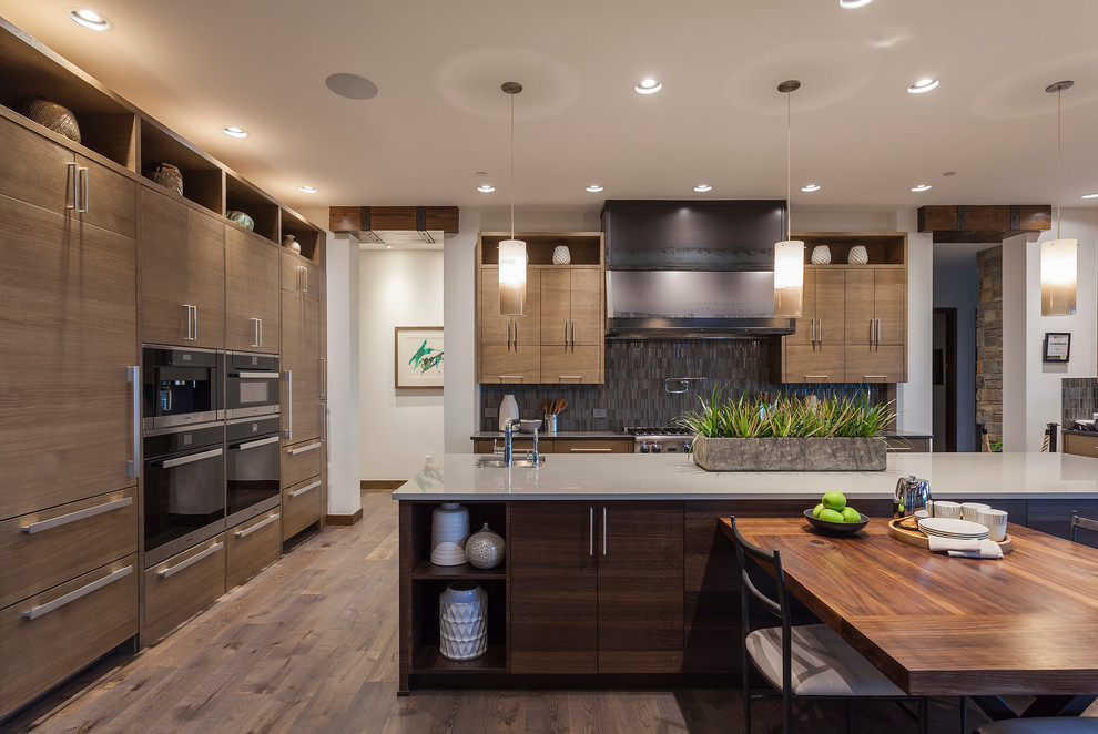 Open concept kitchen - huge contemporary u-shaped dark wood floor open concept kitchen idea in Portland with a double-bowl sink, flat-panel cabinets, distressed cabinets, quartzite countertops, multicolored backsplash, paneled appliances and two islands