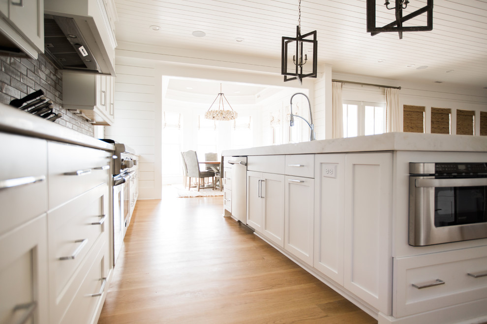 Trendy kitchen photo in Charleston with white cabinets