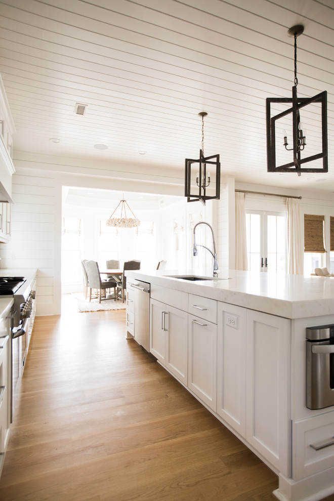 This is an example of a contemporary kitchen in Charleston with white cabinets.