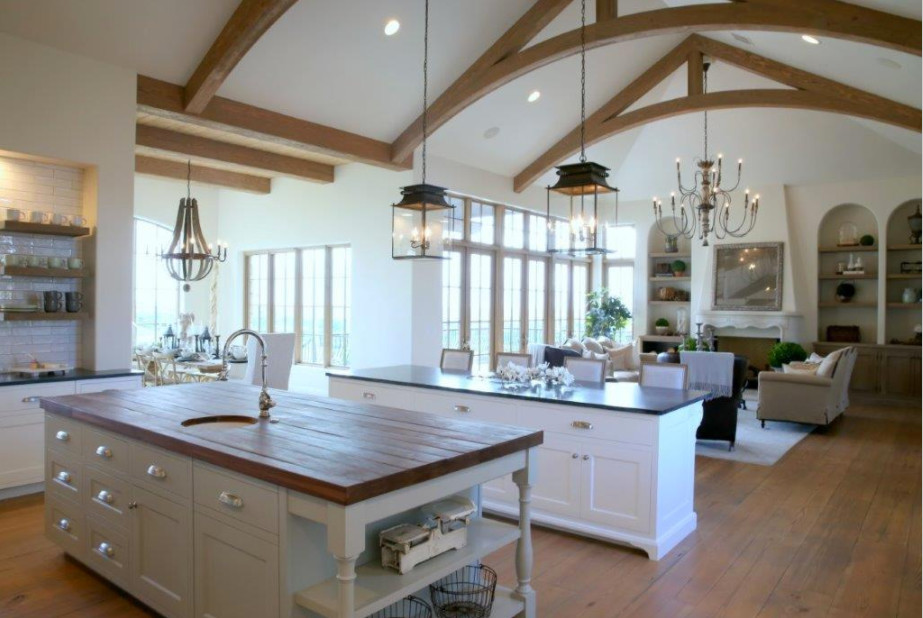 Mid-sized cottage chic u-shaped medium tone wood floor and beige floor eat-in kitchen photo in Orange County with a drop-in sink, raised-panel cabinets, white cabinets, wood countertops, brown backsplash, subway tile backsplash, stainless steel appliances and two islands
