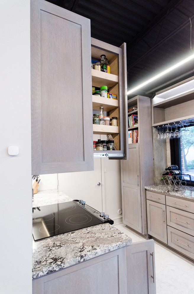 Immagine di una cucina industriale di medie dimensioni con lavello da incasso, ante in stile shaker, ante grigie, paraspruzzi grigio, elettrodomestici in acciaio inossidabile, pavimento in cemento, pavimento bianco e top grigio
