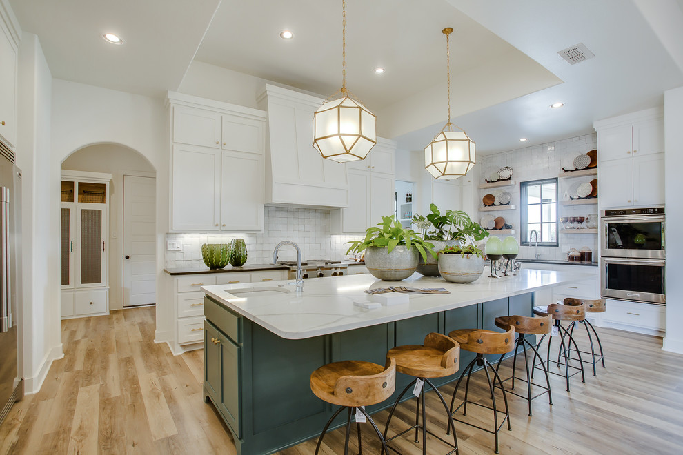 Inspiration for a classic u-shaped kitchen in Other with a submerged sink, shaker cabinets, turquoise cabinets, white splashback, light hardwood flooring, an island, beige floors and white worktops.