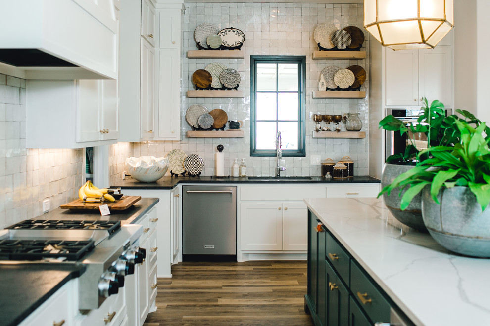 Design ideas for a large traditional kitchen in Austin with shaker cabinets, white cabinets, white splashback, vinyl flooring, an island, brown floors and white worktops.