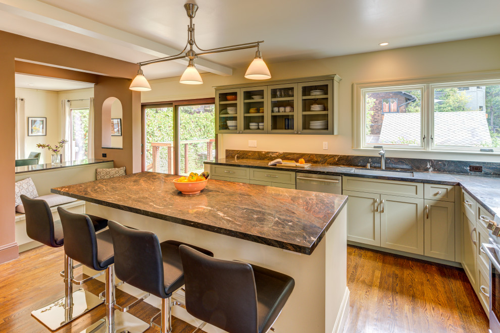 Kitchen - large transitional l-shaped medium tone wood floor kitchen idea in San Francisco with an undermount sink, green cabinets, granite countertops, stainless steel appliances, an island, multicolored countertops and shaker cabinets