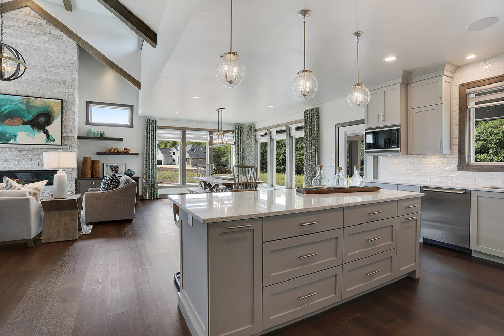 Mid-sized transitional u-shaped vinyl floor and brown floor open concept kitchen photo in Other with an undermount sink, flat-panel cabinets, gray cabinets, quartz countertops, white backsplash, porcelain backsplash, stainless steel appliances, an island and white countertops