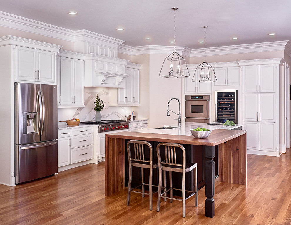 Inspiration for a large transitional l-shaped open concept kitchen remodel in Charlotte with a farmhouse sink, raised-panel cabinets, white cabinets, quartz countertops, multicolored backsplash, stainless steel appliances, an island and multicolored countertops