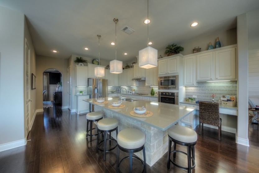 Inspiration for a large transitional dark wood floor eat-in kitchen remodel in Austin with raised-panel cabinets, white cabinets, quartz countertops, gray backsplash, subway tile backsplash, stainless steel appliances and an island