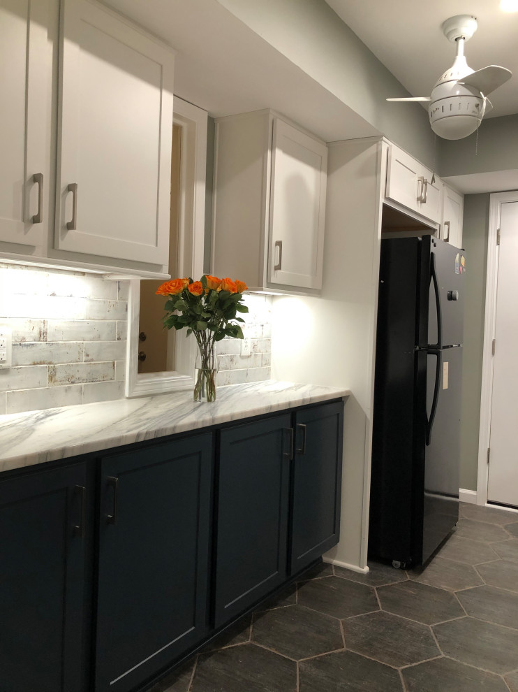 This is an example of a medium sized modern galley enclosed kitchen in Atlanta with a double-bowl sink, shaker cabinets, white cabinets, marble worktops, white splashback, ceramic splashback, stainless steel appliances, ceramic flooring, no island, multi-coloured floors, white worktops and a vaulted ceiling.