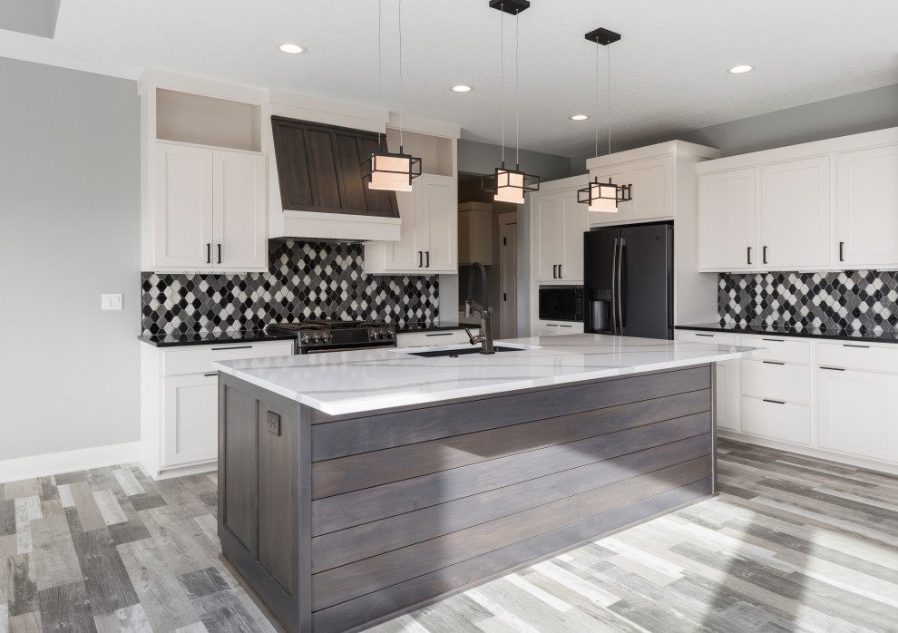 This is an example of a medium sized modern l-shaped open plan kitchen in Other with a submerged sink, shaker cabinets, white cabinets, engineered stone countertops, multi-coloured splashback, ceramic splashback, black appliances, vinyl flooring, an island, grey floors and black worktops.